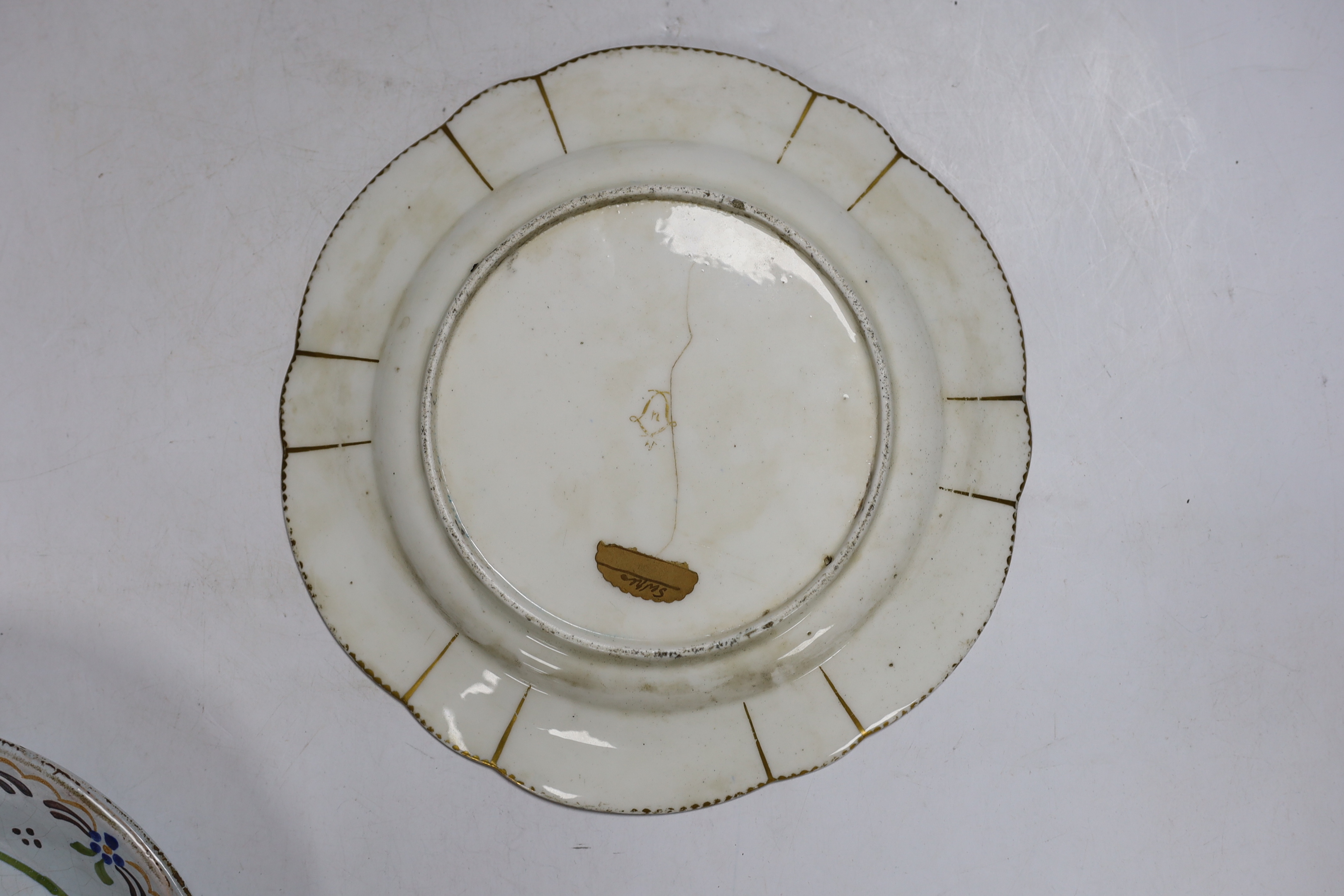 A pair of French revolution commemorative faience dishes and an 18th century Sevres plate, with later decoration, largest 23cm in diameter